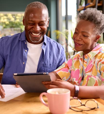 Elderly couple consulting on a tablet with an insurance agent